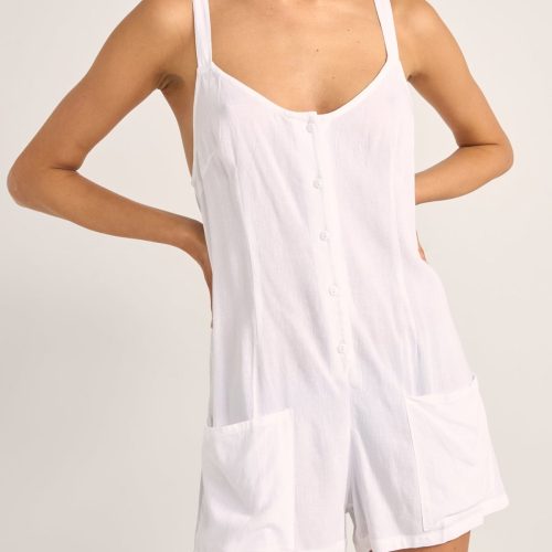 Rhythm Jayda Playsuit in white with adjustable straps, button detailing, and side pockets.